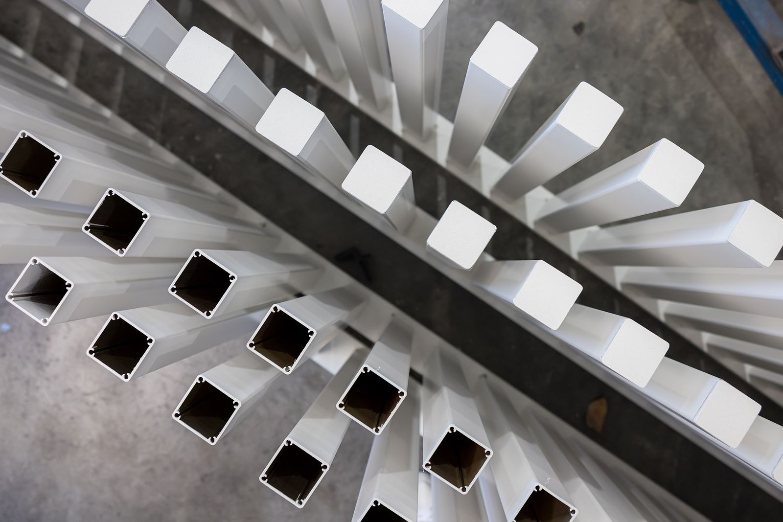 White powder coated aluminium sections on the rack in the AFS workshop